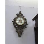 An ornate wall clock with pendulum