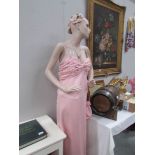 A mannequin in pink gown