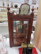 A small astragal glazed cabinet with bevelled mirror back