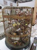 A Victorian taxidermy diorama of birds and butterflies in cage
