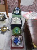 4 boxed glass paperweights