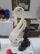 A cast iron swan door stop and one other