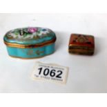 A porcelain pill box and one other