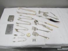 A mixed lot of silver plate cutlery including sugar tongs