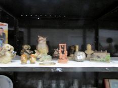 A shelf of owl figures etc