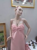 A shop mannequin in pink gown