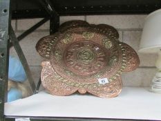 A large ornate brass and copper bowl