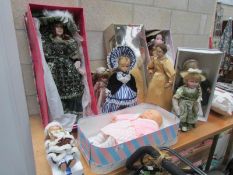 A quantity of porcelain and other dolls