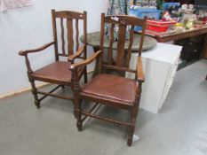 A pair of oak elbow chairs