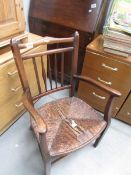 A rush seated elbow chair