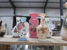 A pair of hand painted glass vases and 3 others