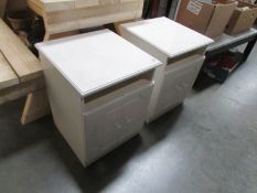 A pair of white bedside cabinets