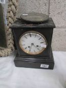 A 19th century black slate clock