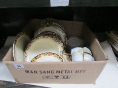 A box of tea and dinner ware