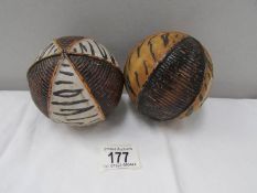 2 painted and carved tribal seed pods?