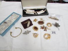 A quantity of costume jewellery including brooches, necklaces,