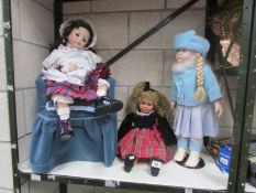 2 large porcelain dolls (one sitting in chair) and one other doll