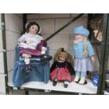 2 large porcelain dolls (one sitting in chair) and one other doll