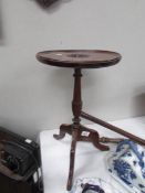 A mahogany tripod table with Tudor rose carved in top