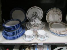 A shelf of assorted dinner ware