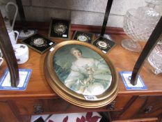 A set of 4 circular porcelain plaques and an oval picture on silk