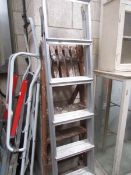 An aluminium step ladder and a wooden step ladder