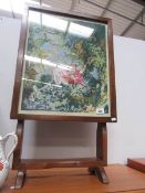 An oak framed firescreen with tapestry inset