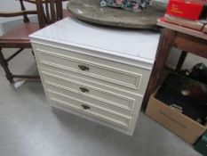 A white 3 drawer chest