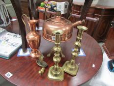 A copper whistling kettle, a brass trivet, a pair of brass candlesticks,
