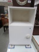 A white bedside cabinet