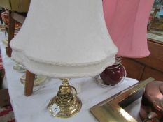 A brass table lamp and one other