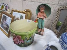 A jardiniere and a plaster figure of boy with umbrella