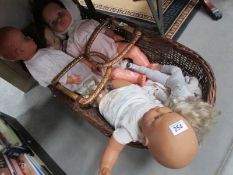 A Moses basket and dolls