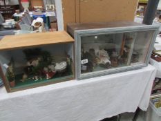 A cased doll display and a one other