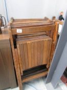 A set of 8 folding wooden chairs (some with worn markings)