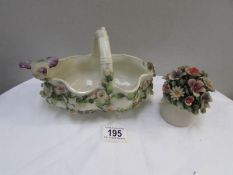 A floral encrusted basket surmounted bird and a porcelain posy