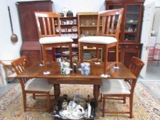 A draw leaf table and 4 chairs
