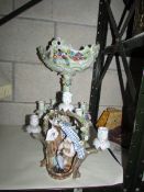 A continental porcelain table centrepiece and candelabra,