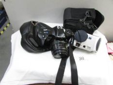 An Olympus OM101 camera and a Sony cyber-shot digital camera