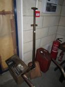 A garden spade, garden fork, large fuel can,