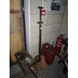 A garden spade, garden fork, large fuel can,