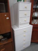 A white 5 drawer chest and matching bedside chest