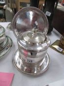 A silver plated biscuit barrel and tray