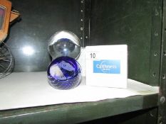 A boxed crystal ball and a Caithness paperweight