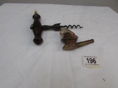 A 19th century corkscrew with brush and a pipe with bowl in the form of a Georgian lady's head a/f