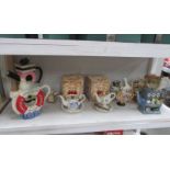 A collection of Cardew teapots including Lilliput Lane market stall