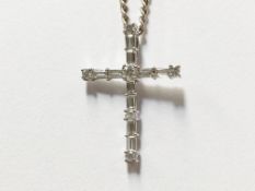 A baguette and round cut diamond cross in 18ct white gold
