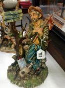 A Capo Di Monte figure of a travelling tramp with dog signed Maria Angelo,