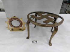 A WW2 brass and copper photo frame stamped 'FUHRER ADOLF 1943' and a brass trivet depicting a