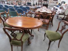 An oval mahogany dining table and a set of 4 chairs